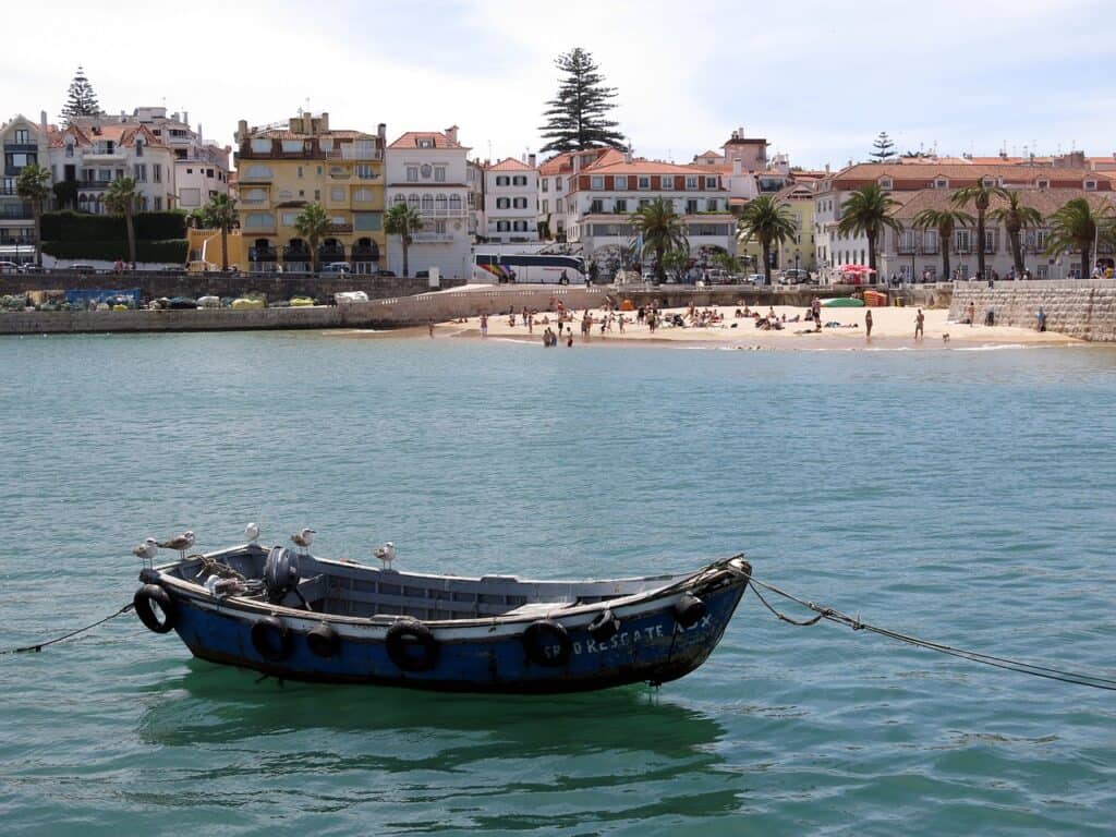 Anchored boat floating near a beach in Cascais