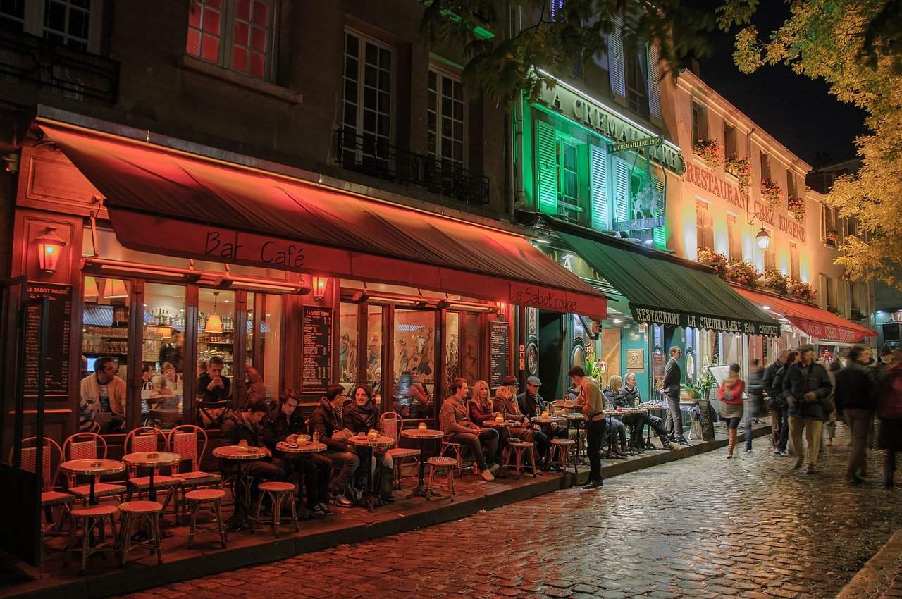Busy Parisian street in Montmartre at Night
