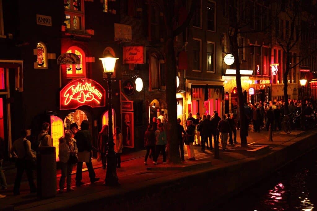 A lot of people strolling through De Wallen's Red Light District in Amsterdam at night