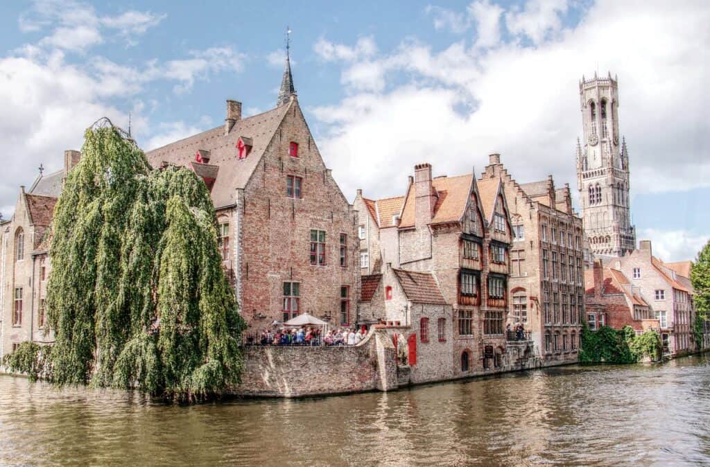 Iconic corner in Bruges known as Rosary Quay with brick buildings and a lot of greenery over the canal