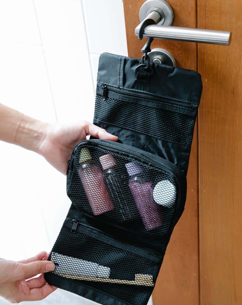 Black hanging toiletry bag with small bottles