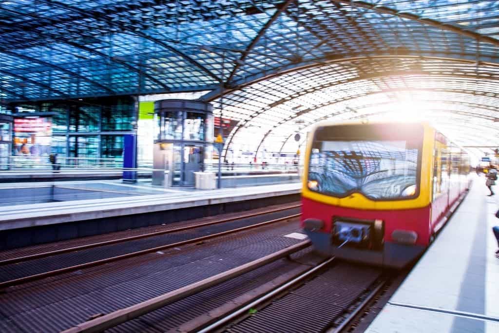 Yellow train entering a station at speed