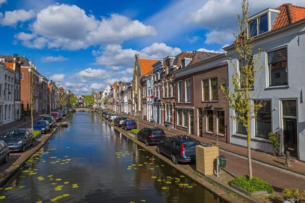 Gouda, Netherlands canal with buildings on either side on a cloudy day