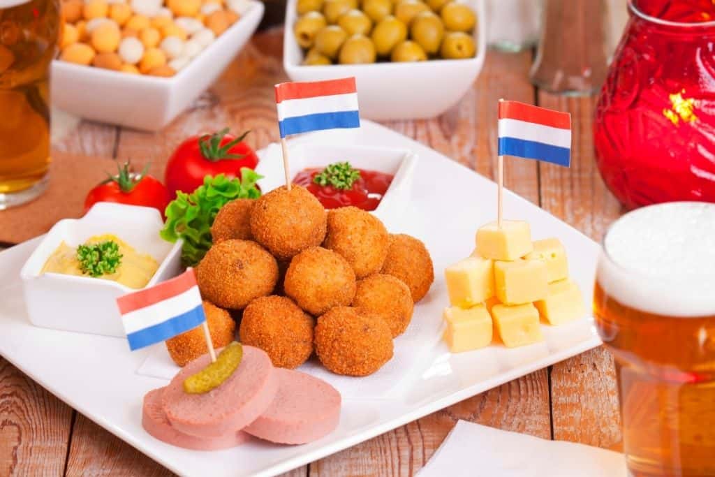 Plate of bitterballen (mini fried meat balls) with Netherlands flag toothpicks on a plate