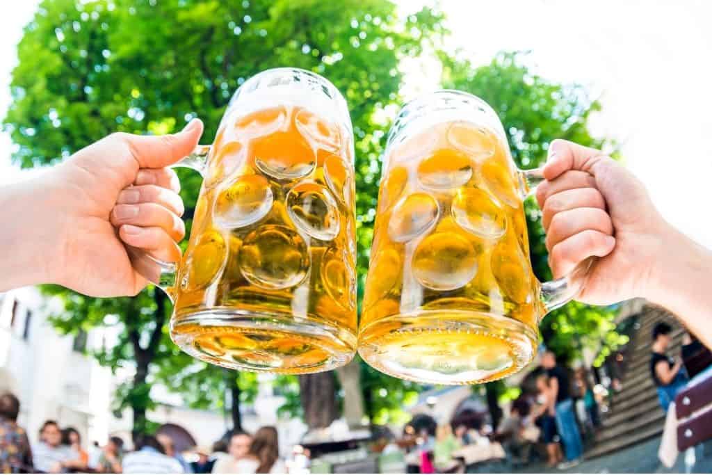 Two large beer steins at an outdoor cafe in Germany