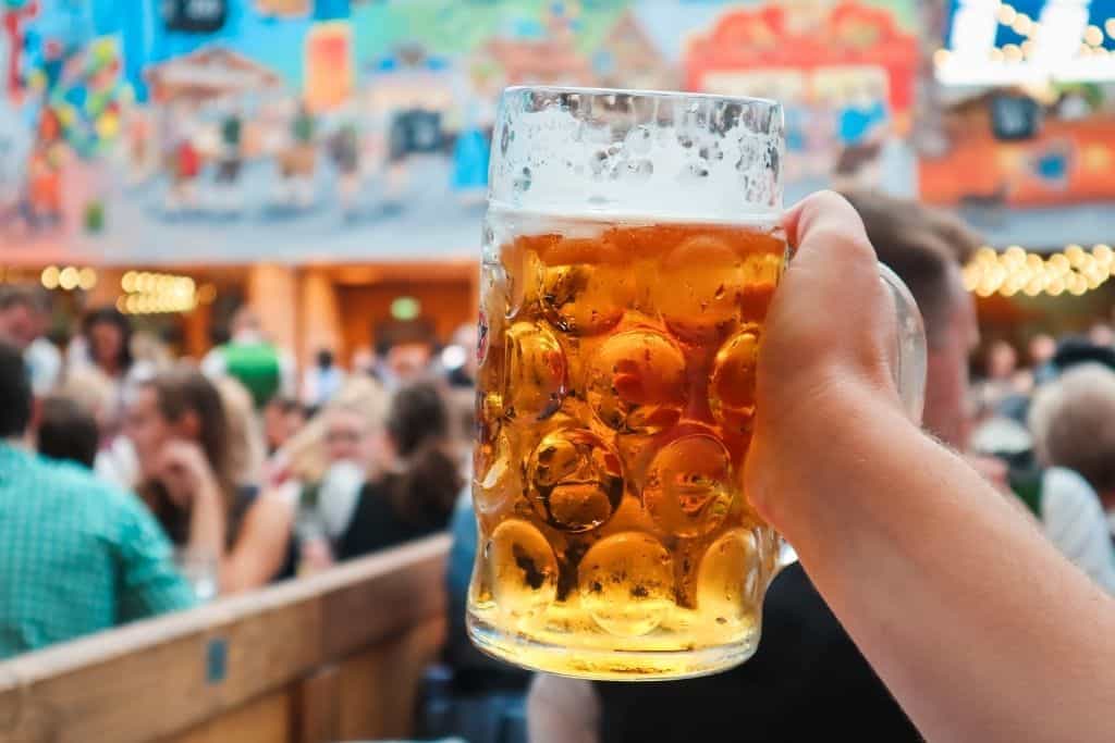 Large beer pint in a crowded tent of people