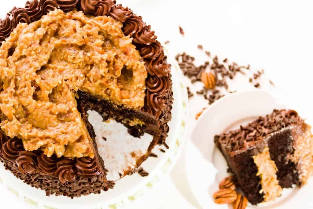 Large black forest cake with a slice on a small plate