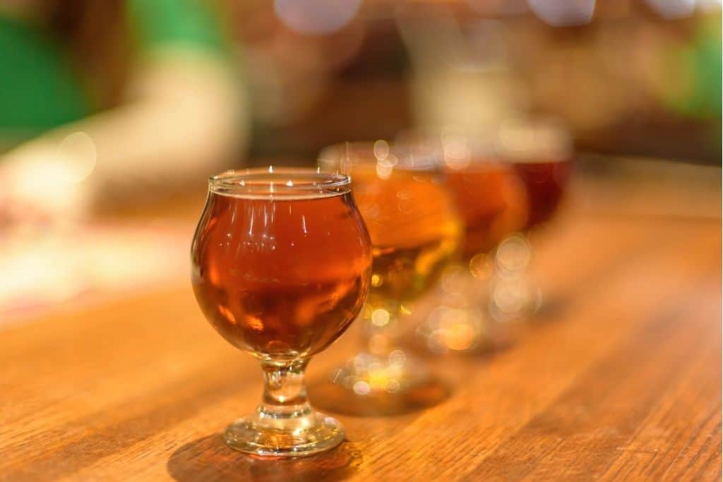 Row of tulip glasses on a wooden table