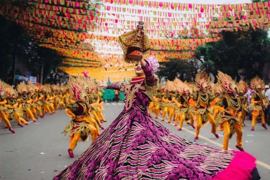 People dancing in traditional clothing at a festival