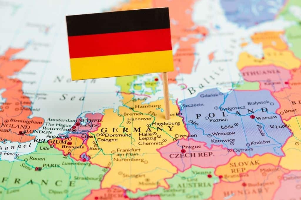 German flag on a toothpick sticking into Germany on a map