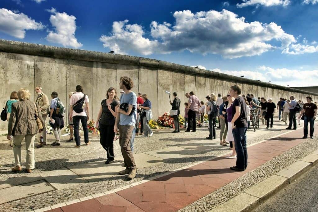 Crowds of people walking along the Berlin Wall in Germany