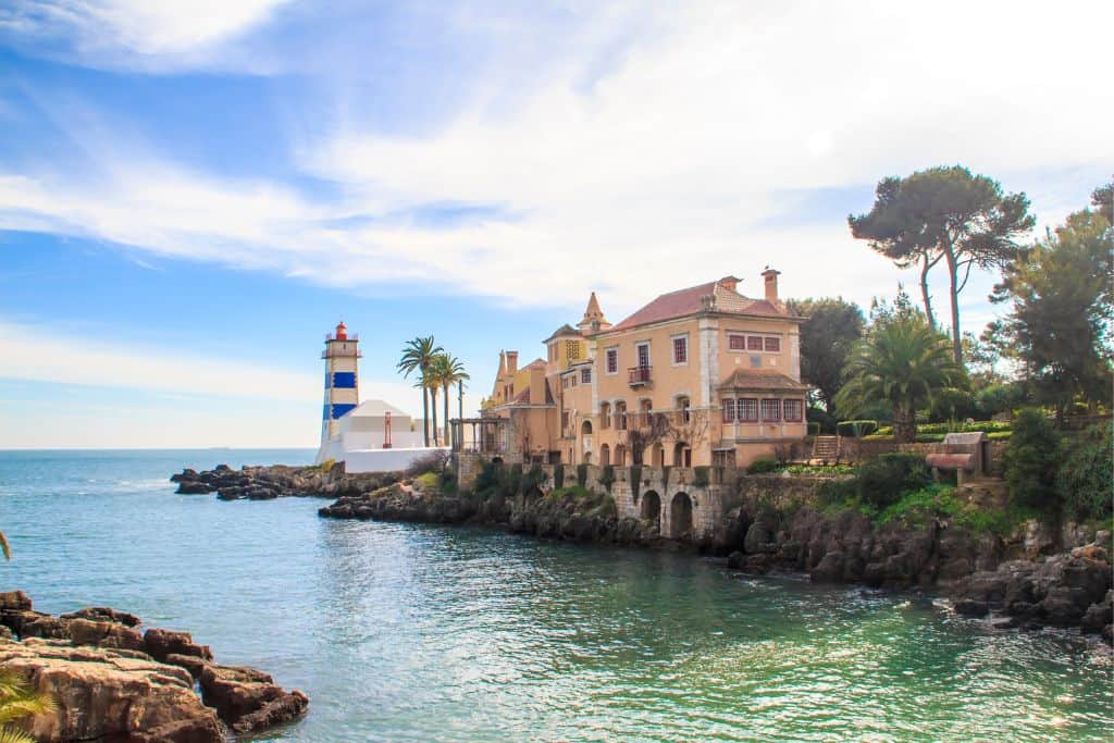 Blue and white lighthouse outside of Cascais, Portugal