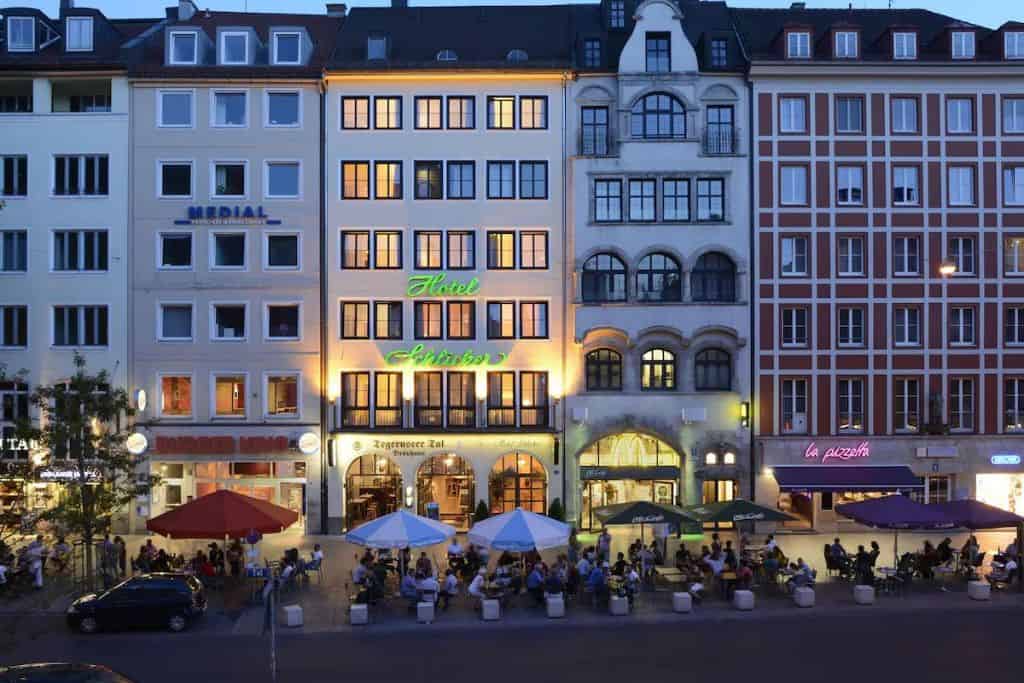 Busy cafes at night underneath tall hotels in Germany