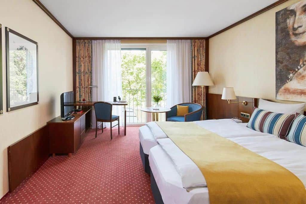 Red rug and hold linens in a modern hotel room