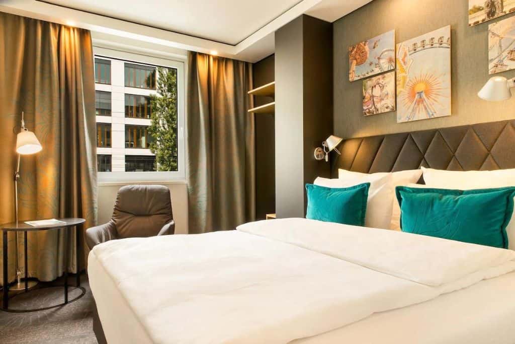 White hotel room with blue and brown accents
