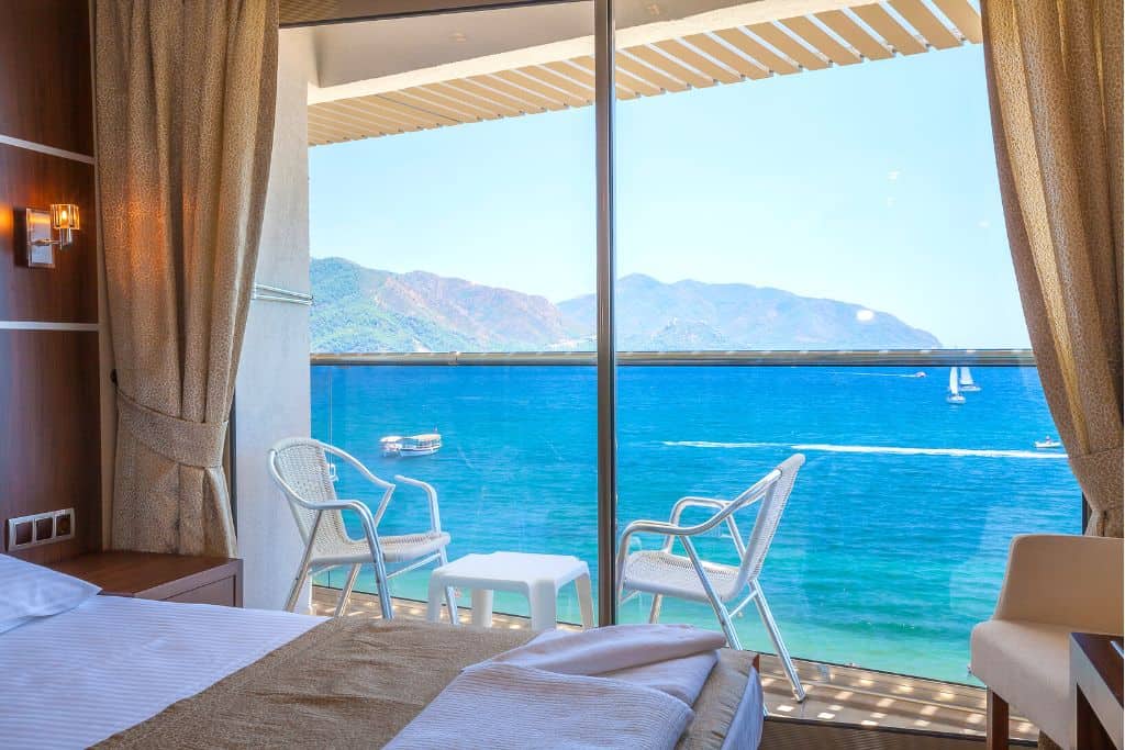 Hotel room with a balcony overlooking the ocean and mountains