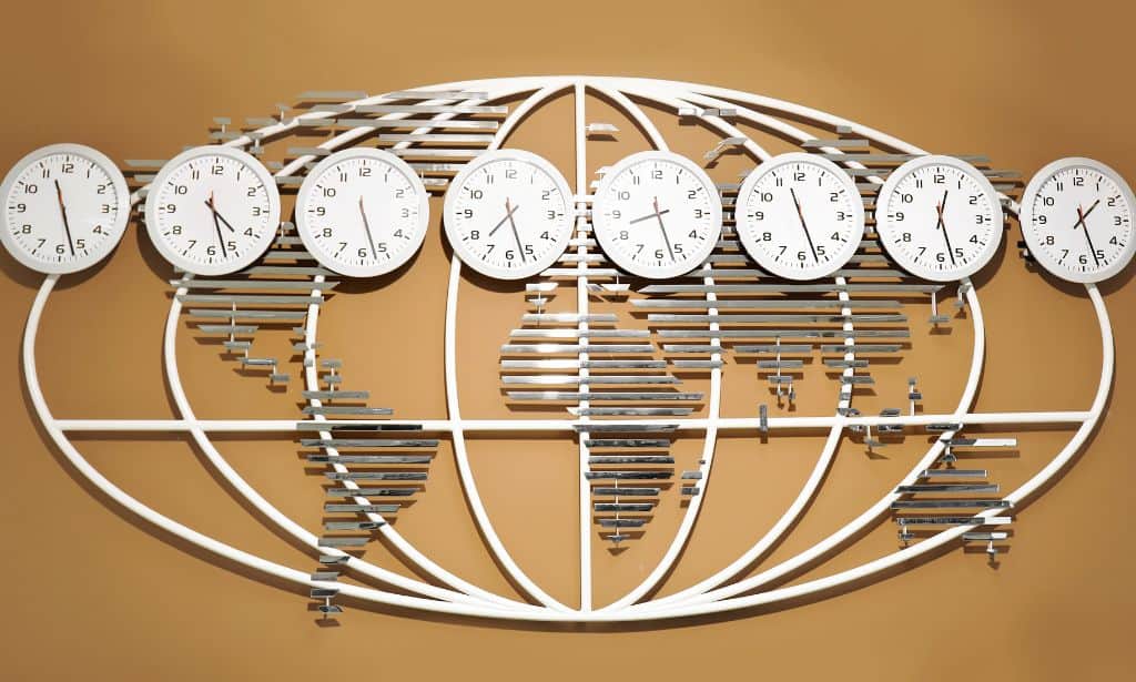 Flat metal map on a wall with 8 time zone clocks on top