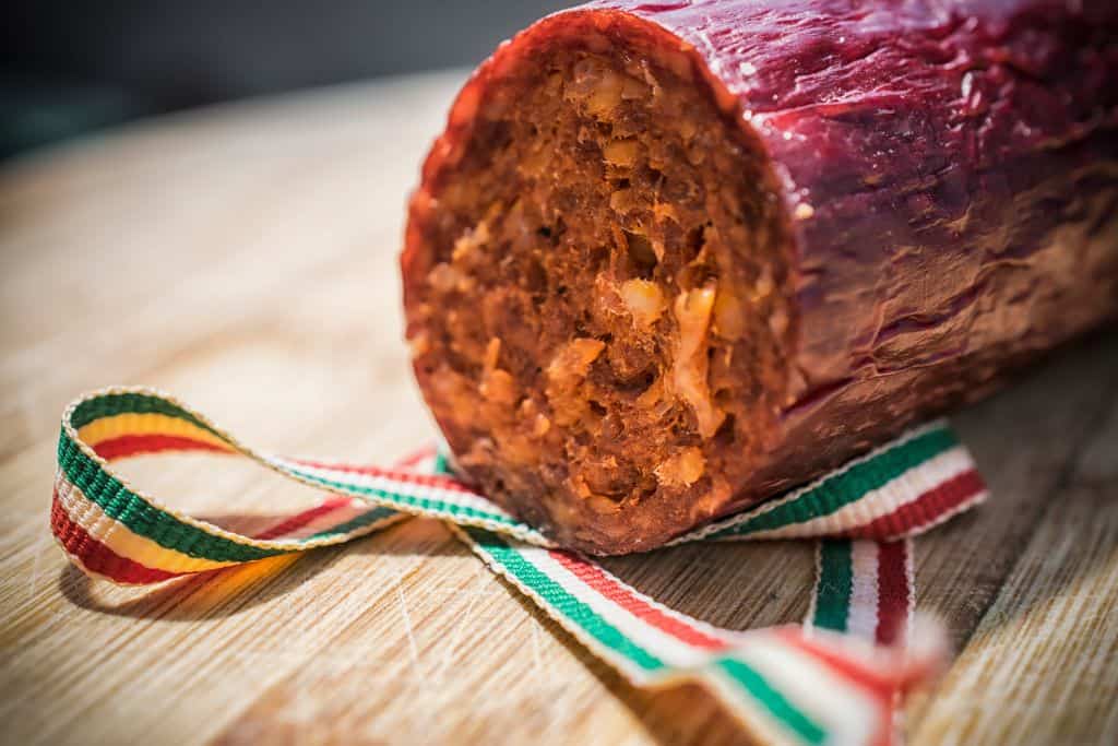 Inside of a red sausage with a ribbon around it