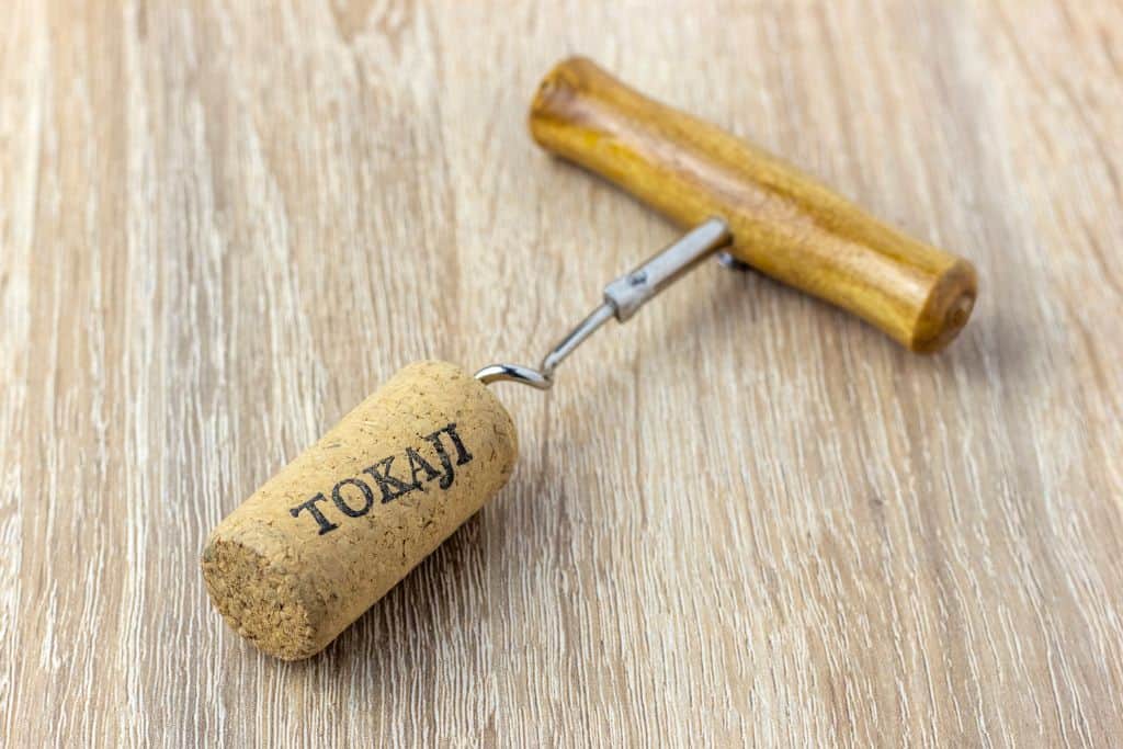 Cork screw opener with a wine cork that says "Tokaji"