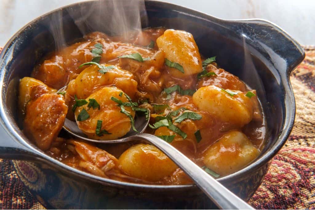 Hot bowl of goulash with a metal spoon