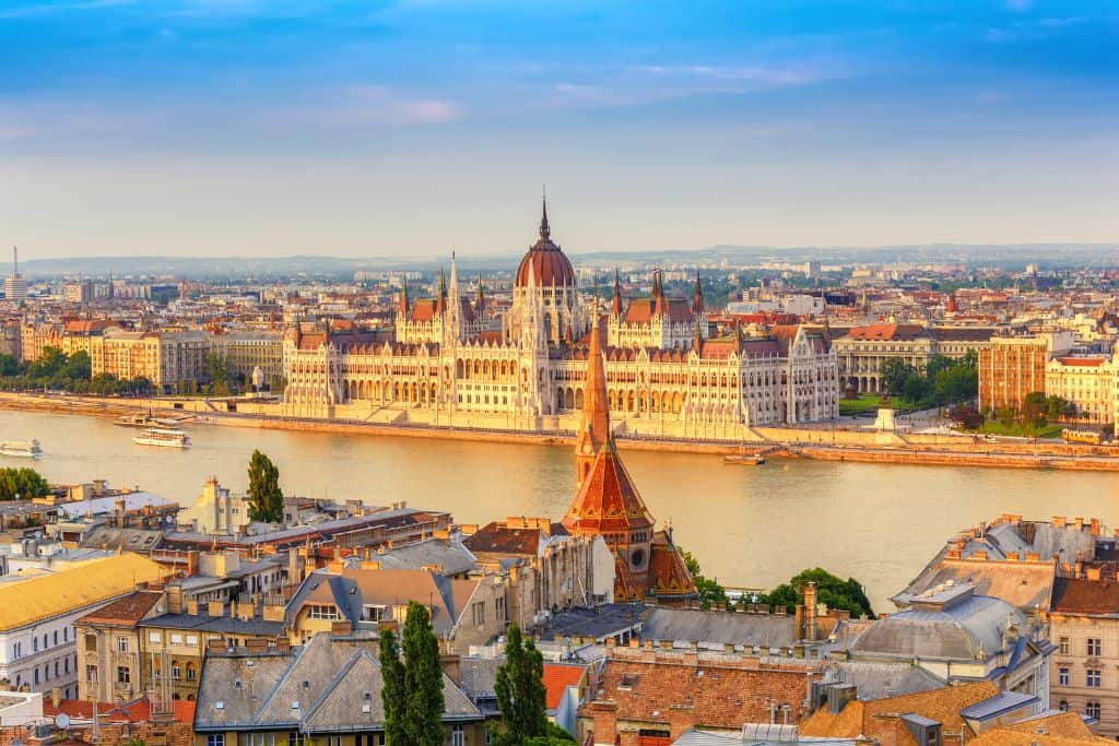 Aerial view of the Danube and Parliament Building at sunset in Budapest