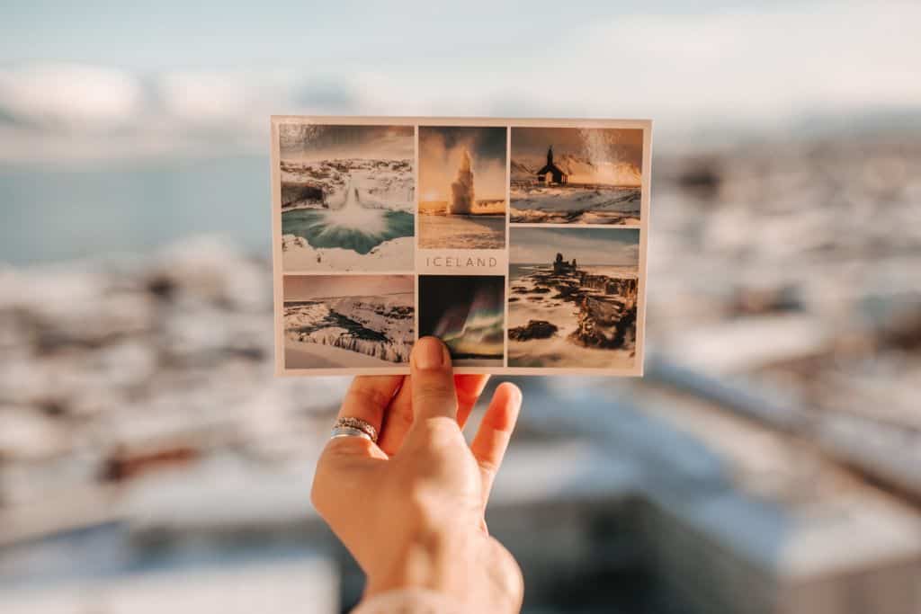 Someone holding up a post card