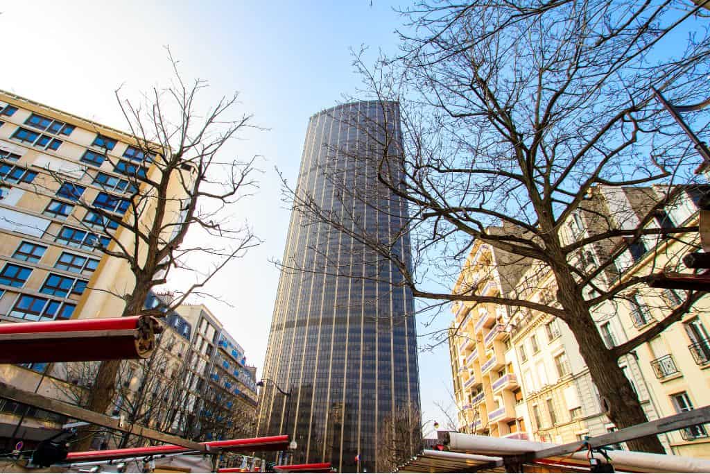 Tour Montparnasse surrounded by smaller buildings and dead trees in Paris
