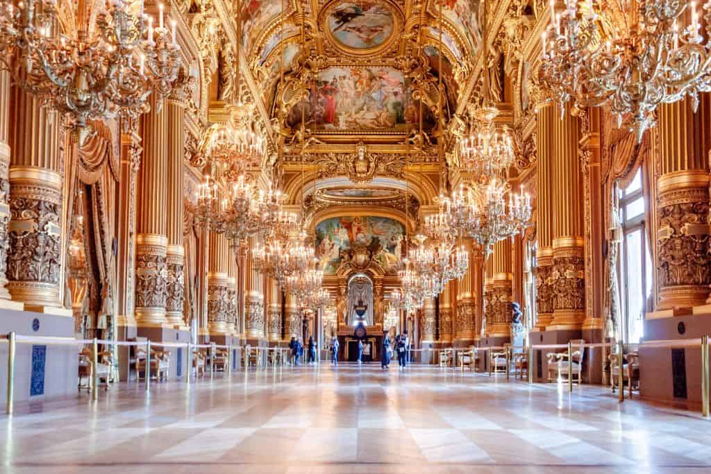 Long, wide hallway covered in intricate details and luxury gold paint
