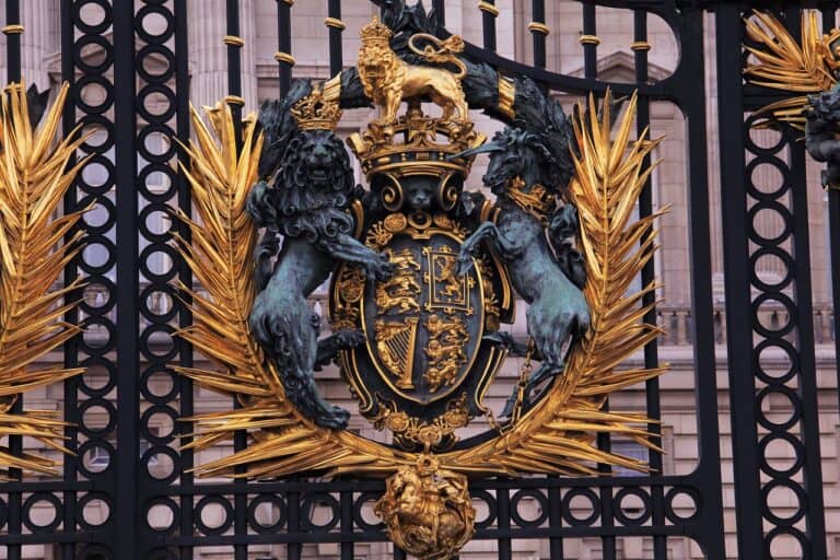 The Royal Coat of Arms of the United Kingdom on a tall metal gate