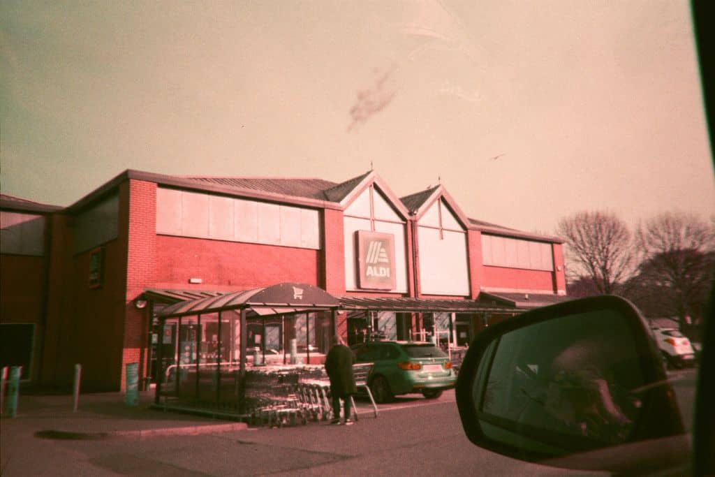 Sepia photo of an Aldi storefront and parking lot