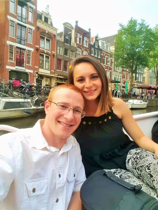 Man and woman enjoying a canal ride in Amsterdam