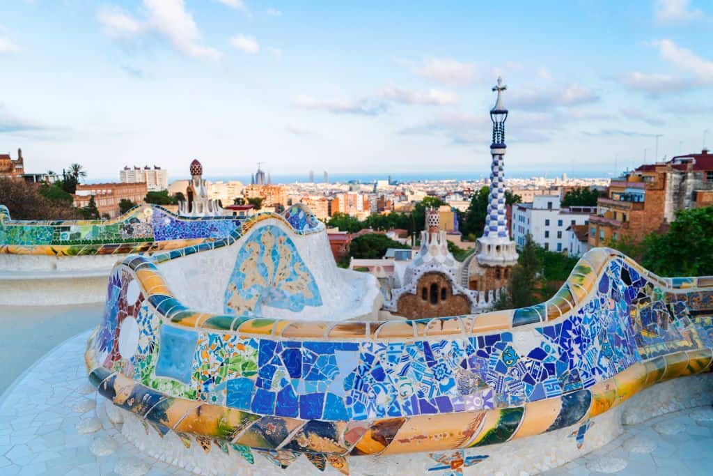 Windy bench backed by vibrant tiles on a lookout in Park Guell