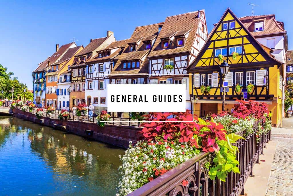 Vibrant, old buildings on a canal with the words "General Guides" in a white box