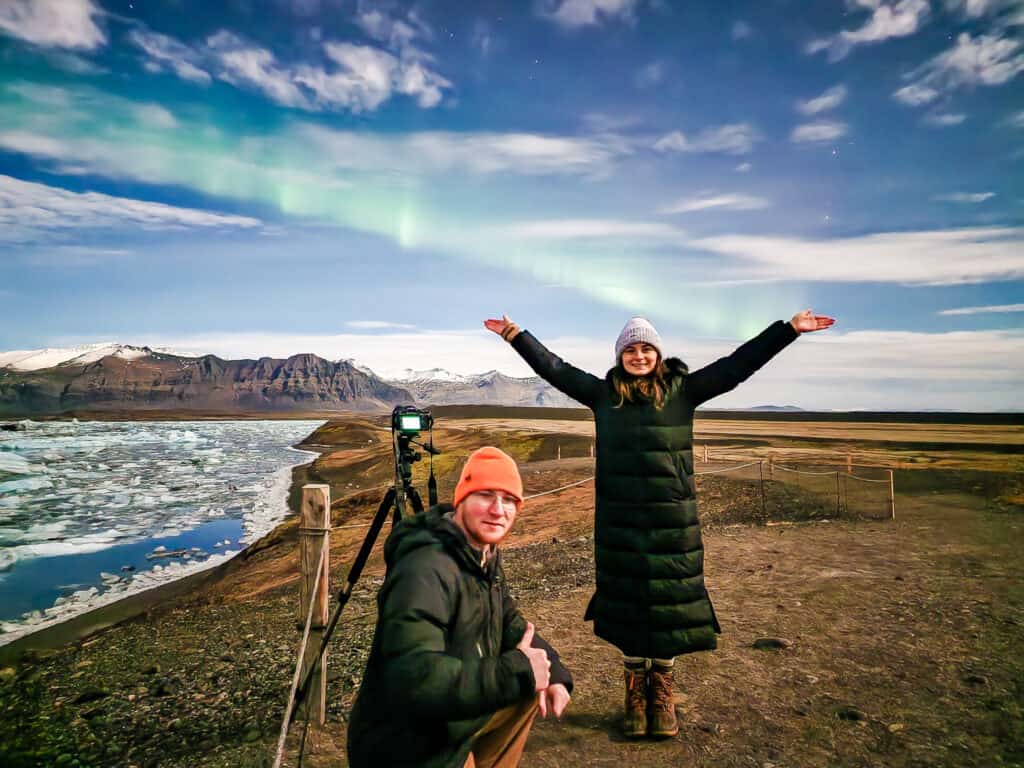 Man and woman in Iceland under the northern lights