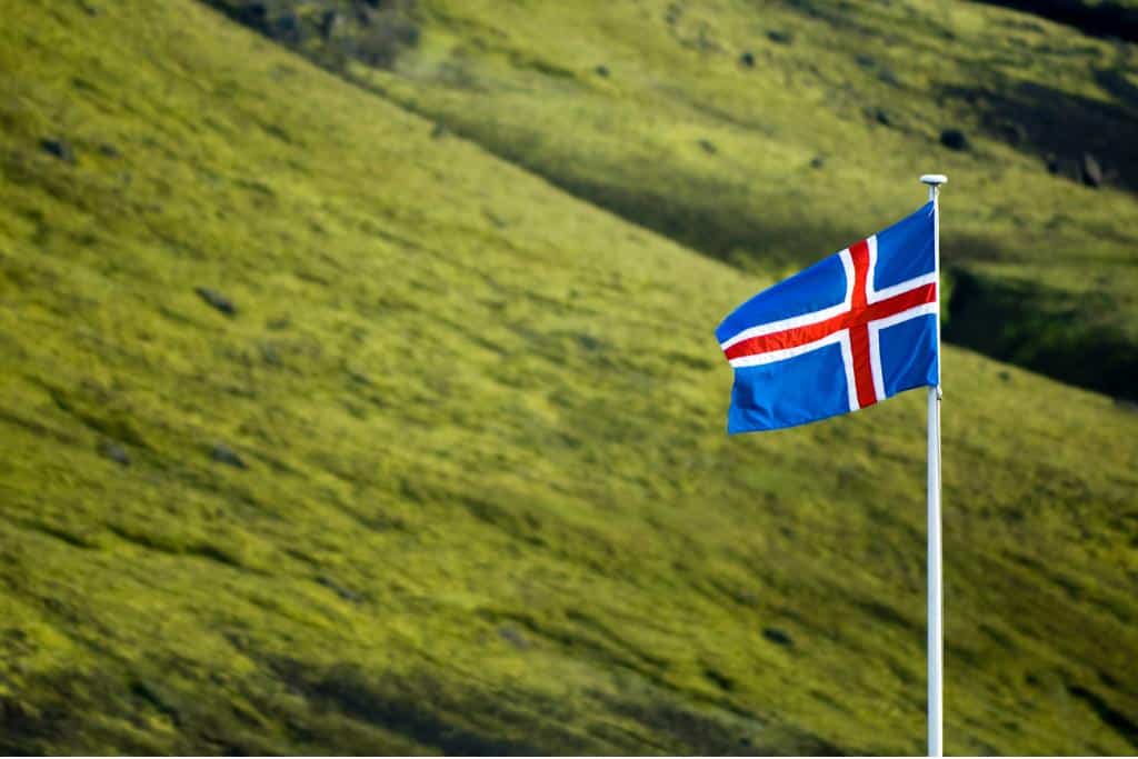 Iceland flag over the green countryside