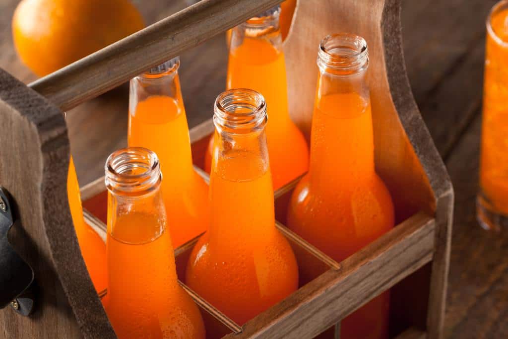 6 bottles of orange appelsín in a wooden carrying case