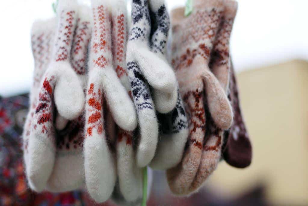 Icelandic wool mittens hanging upside down