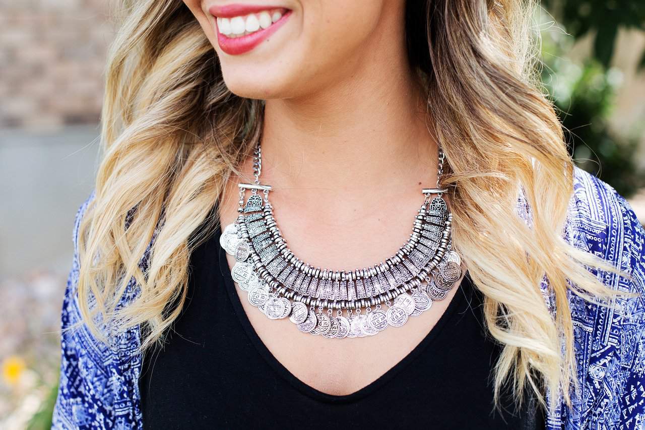 Woman wearing a large, metal necklace