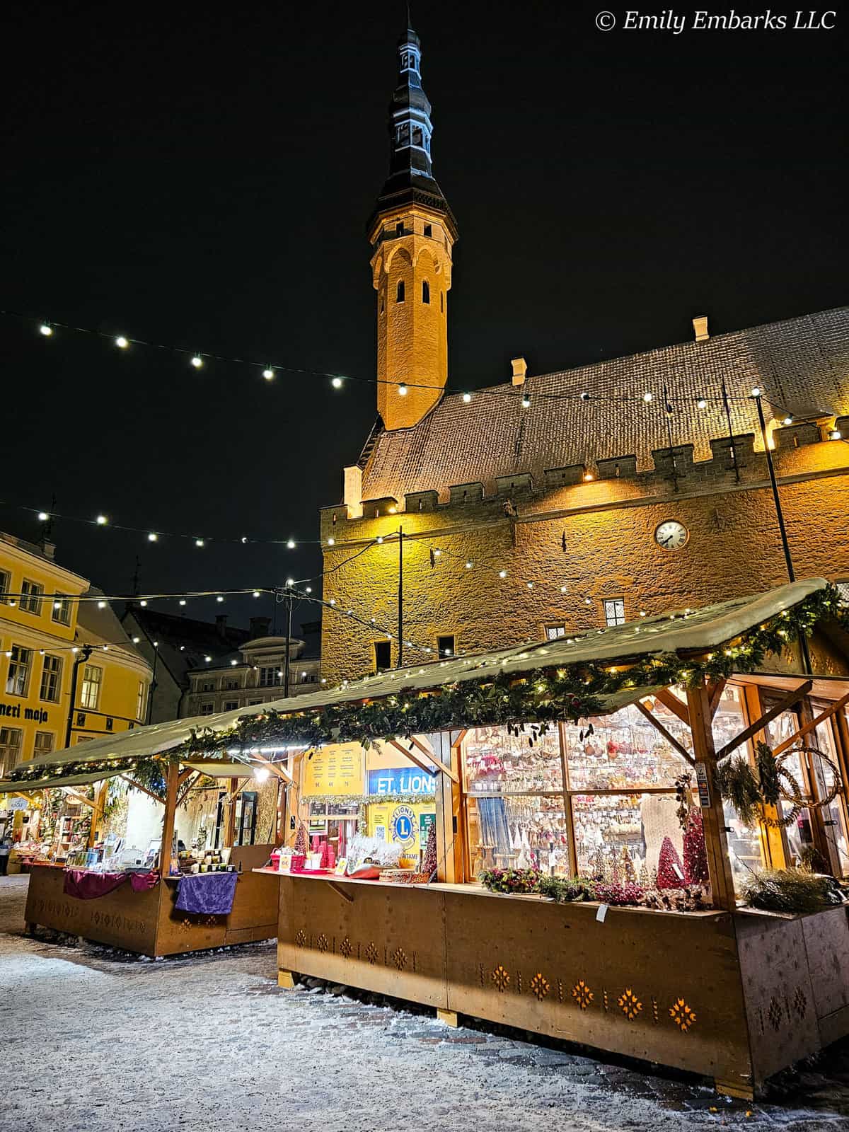 Tallinn's Town Hall surrounded by wooden booths at Christmas