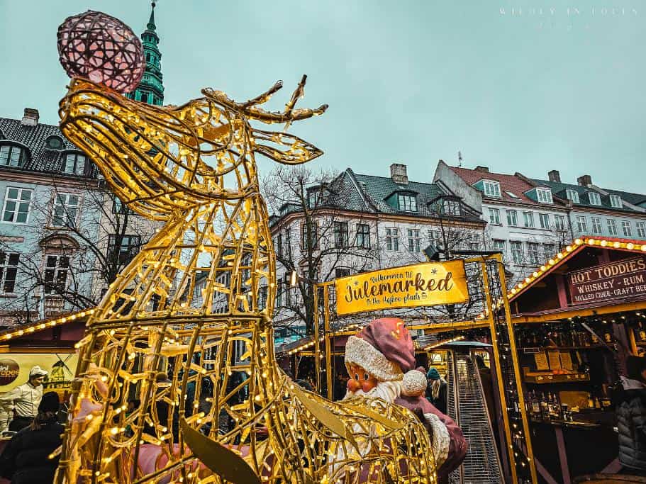 Højbro Plads in Copenhagen at Christmas with a close up of their iconic illuminated reindeer