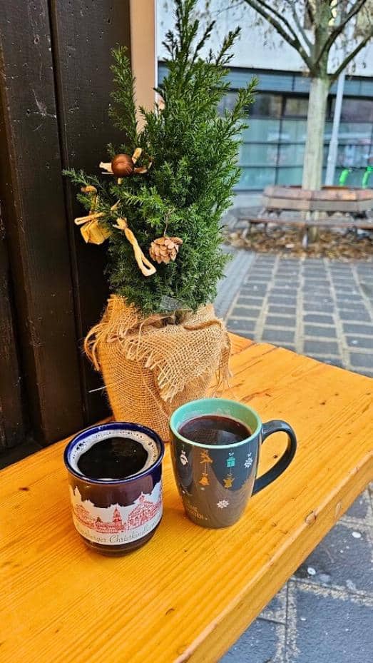 2 mugs of mulled wine on a wooden table