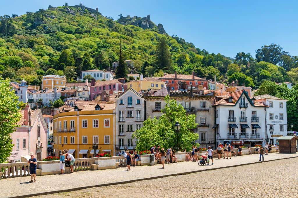 Downtown Sintra with colorful buildings backed by tree-covered hills