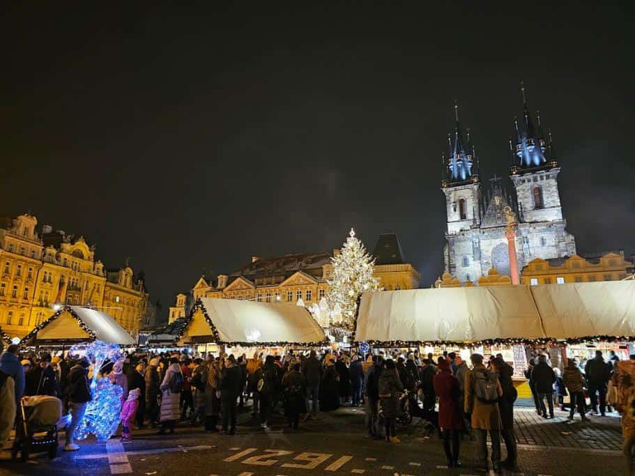 Prague's Old Town Christmas market with tents and tons of people