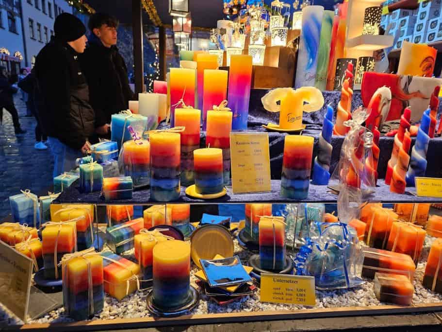 vibrant layered candles in a glass display