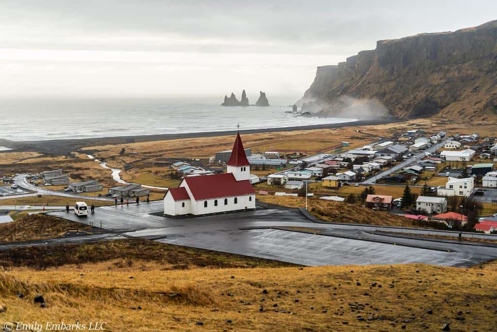 Iconic photo of the church and black sand beach in Vik, Iceland