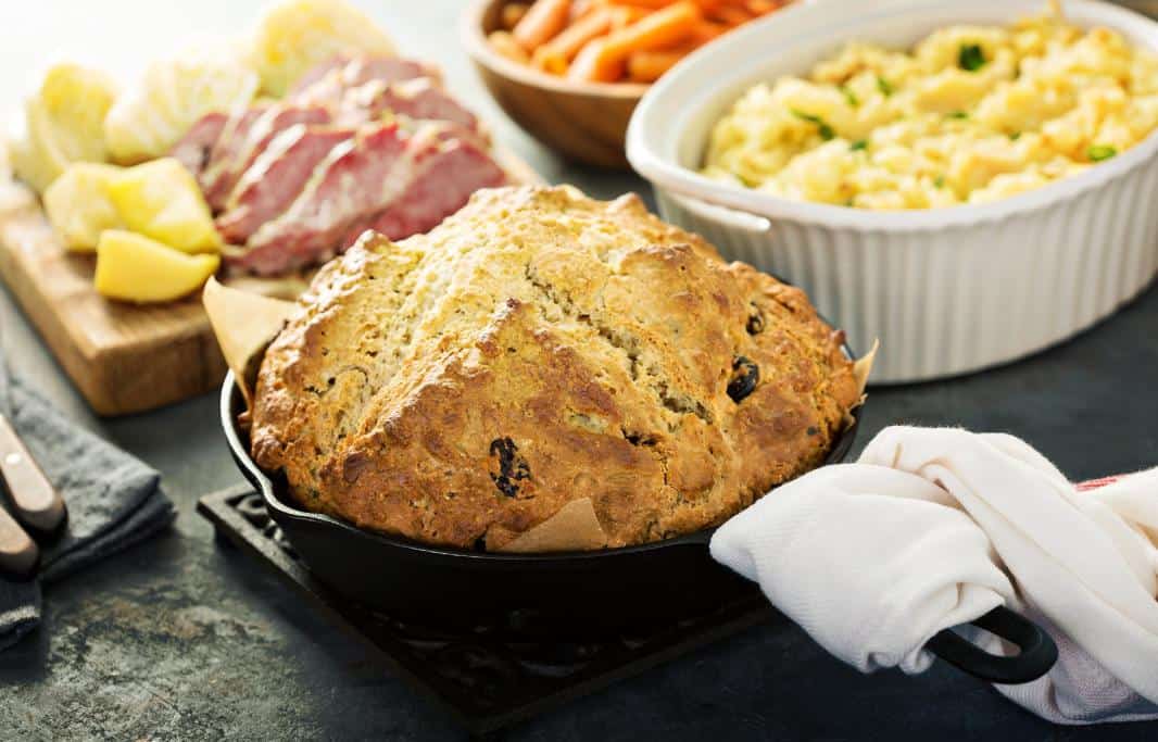 Table covered in Irish classics like Irish soda bread and Colcannon