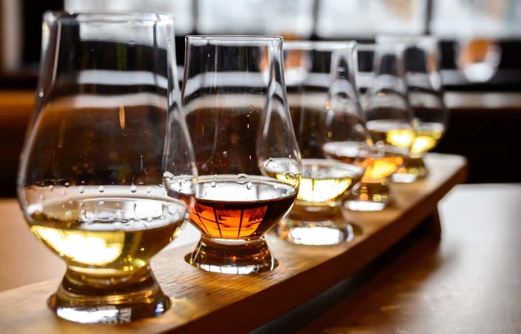 Flight of different colored whiskeys