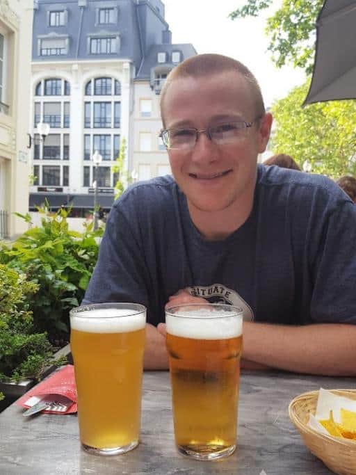 Sean and Emily at a table in Luxembourg City with 2 pints of beer