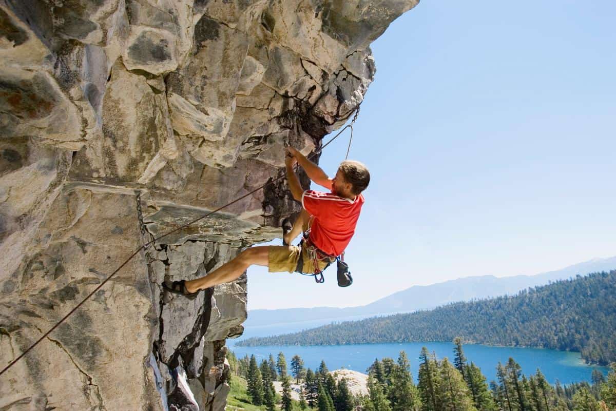 Person rock climbing on a large ledge