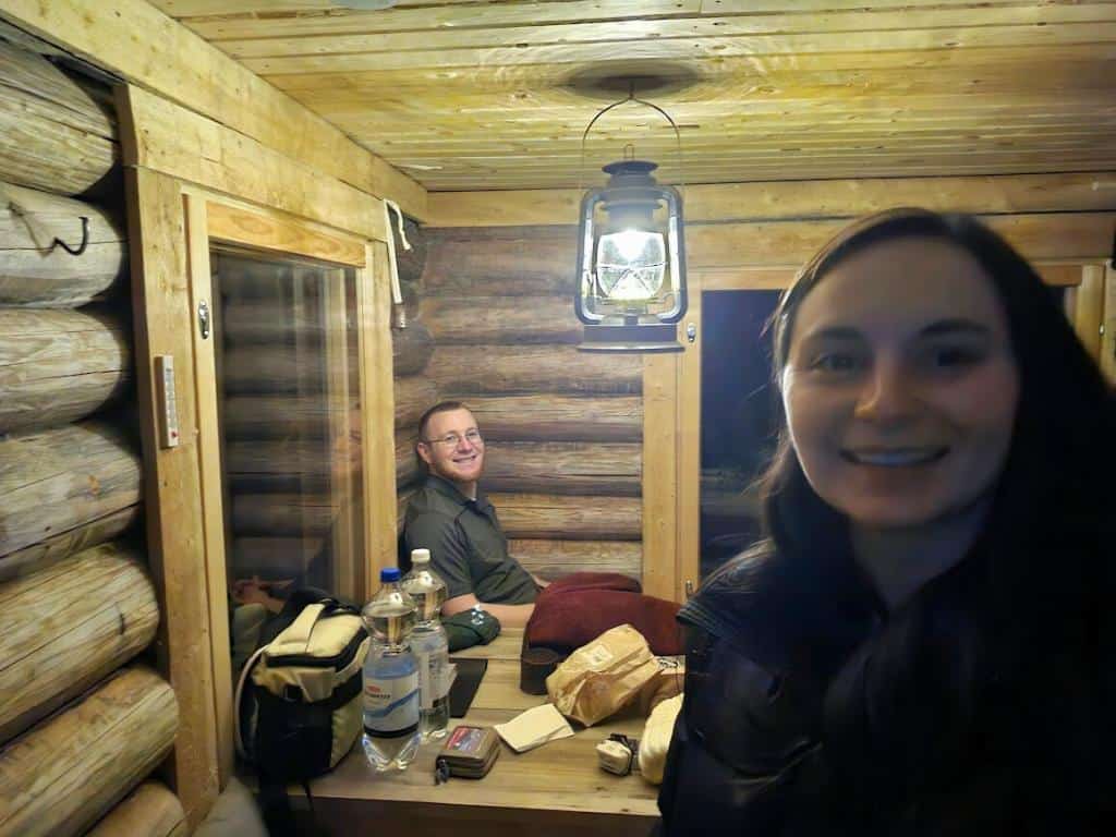 Emily and Sean Concannon in a log cabin in Rovaniemi, Finland in winter